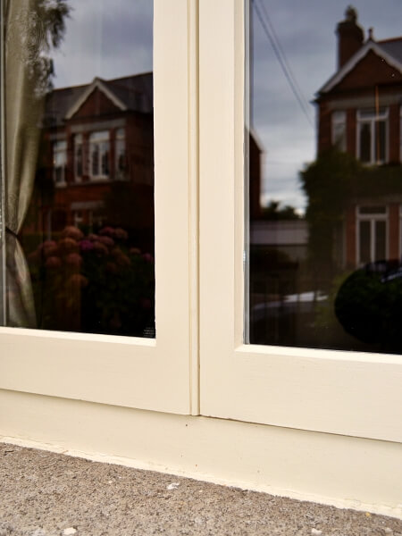 Close-up photograph of new white double glazed casement windows with granite windows sills.